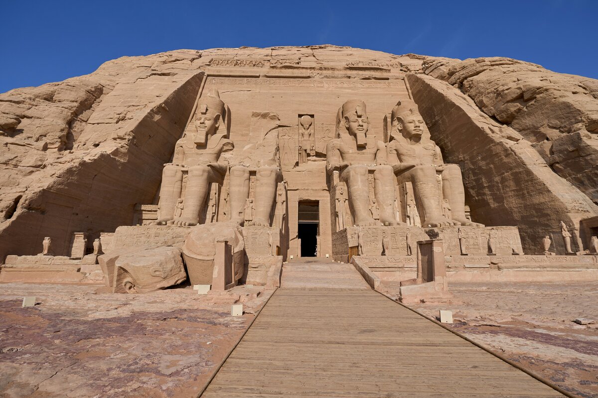 Abu Simbel temples with seated statues of Ramses II under morning sun