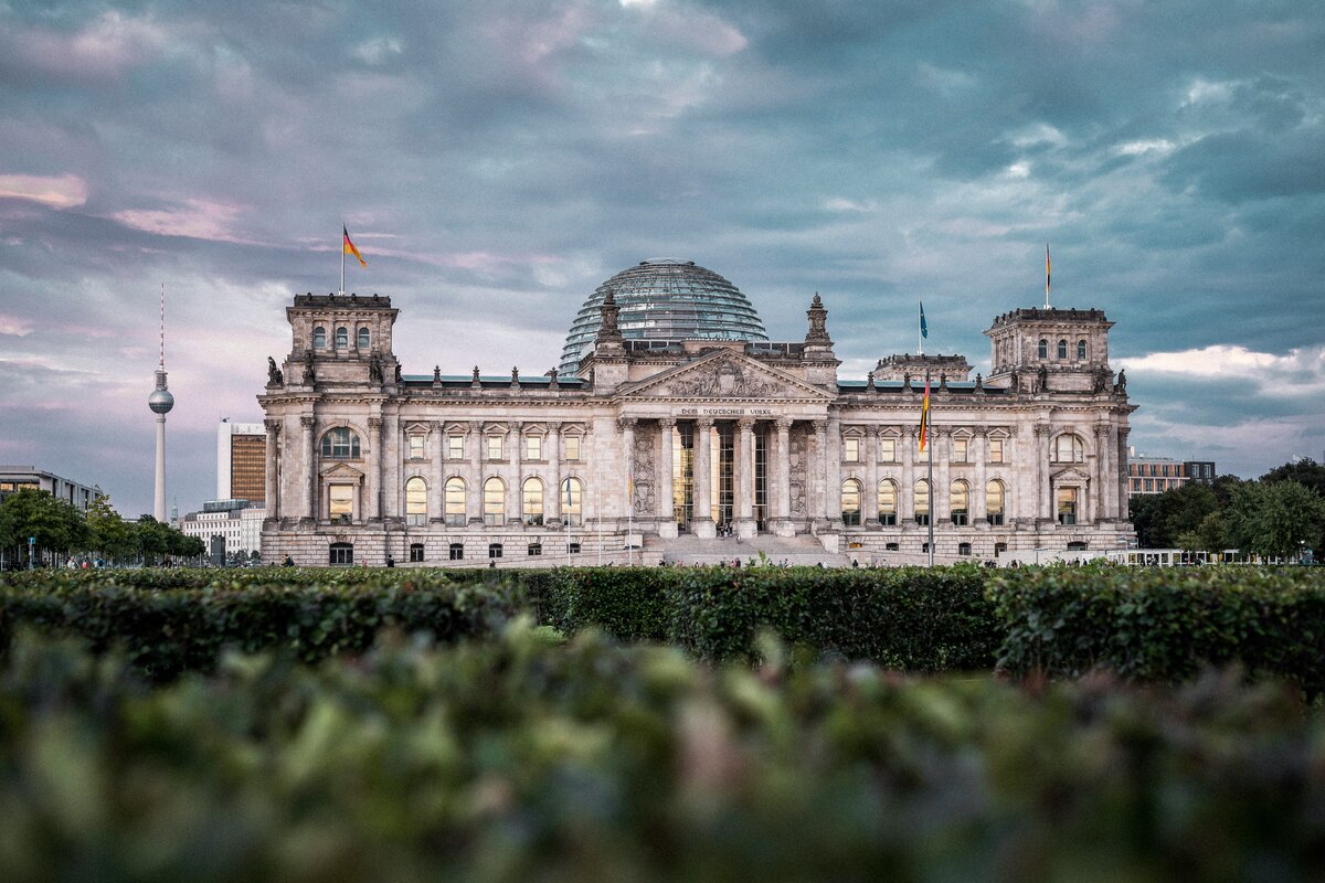 Berlin Reichstag dome at evening — glass architecture and city skyline