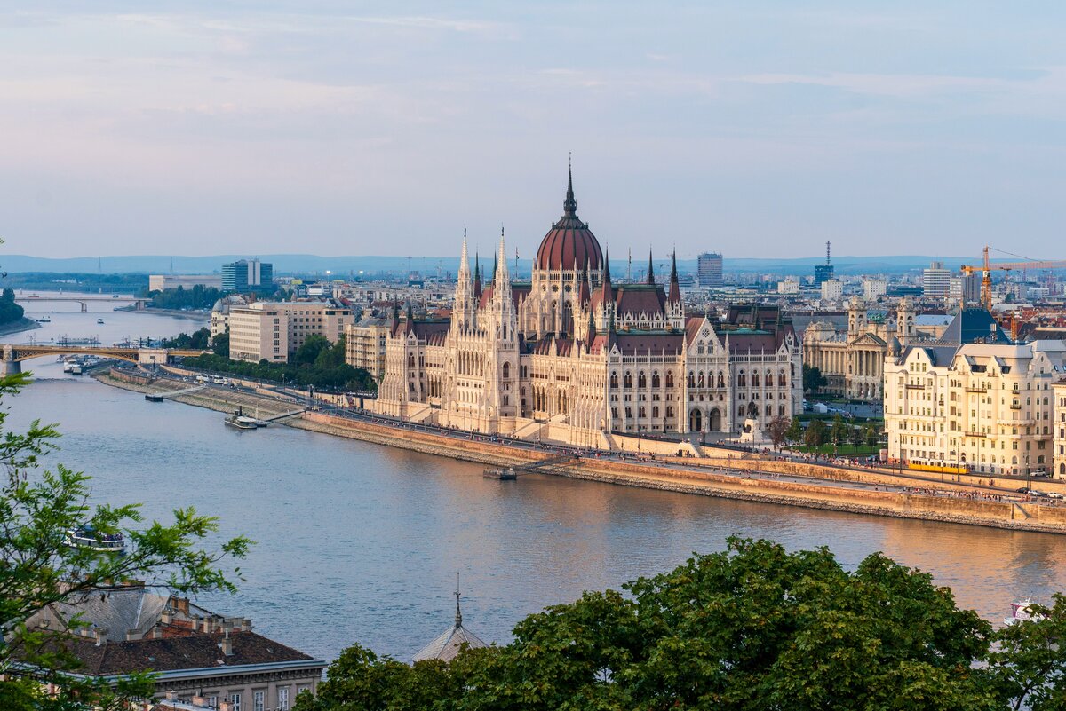 Budapest Parliament glowing on the Danube at night