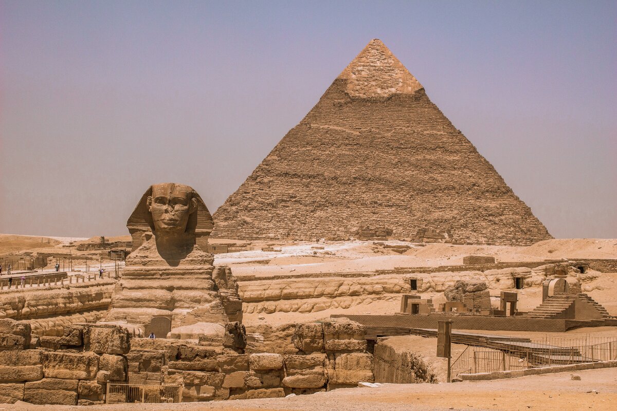 The Great Pyramids of Giza and Sphinx under golden sunlight