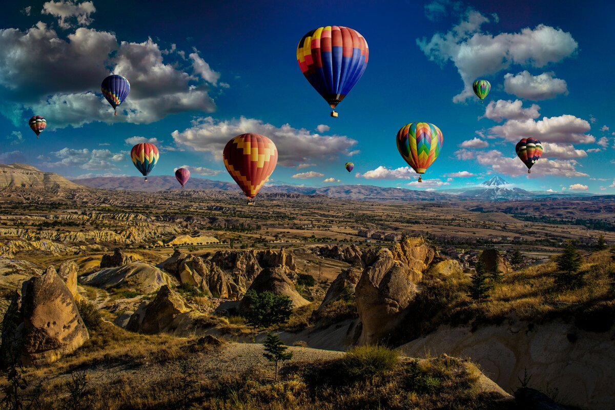 Hot air balloons rising over Cappadocia's fairy chimneys