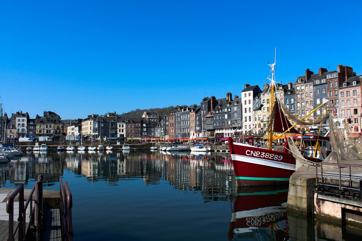 Honfleur old harbor with colorful houses and sailboats