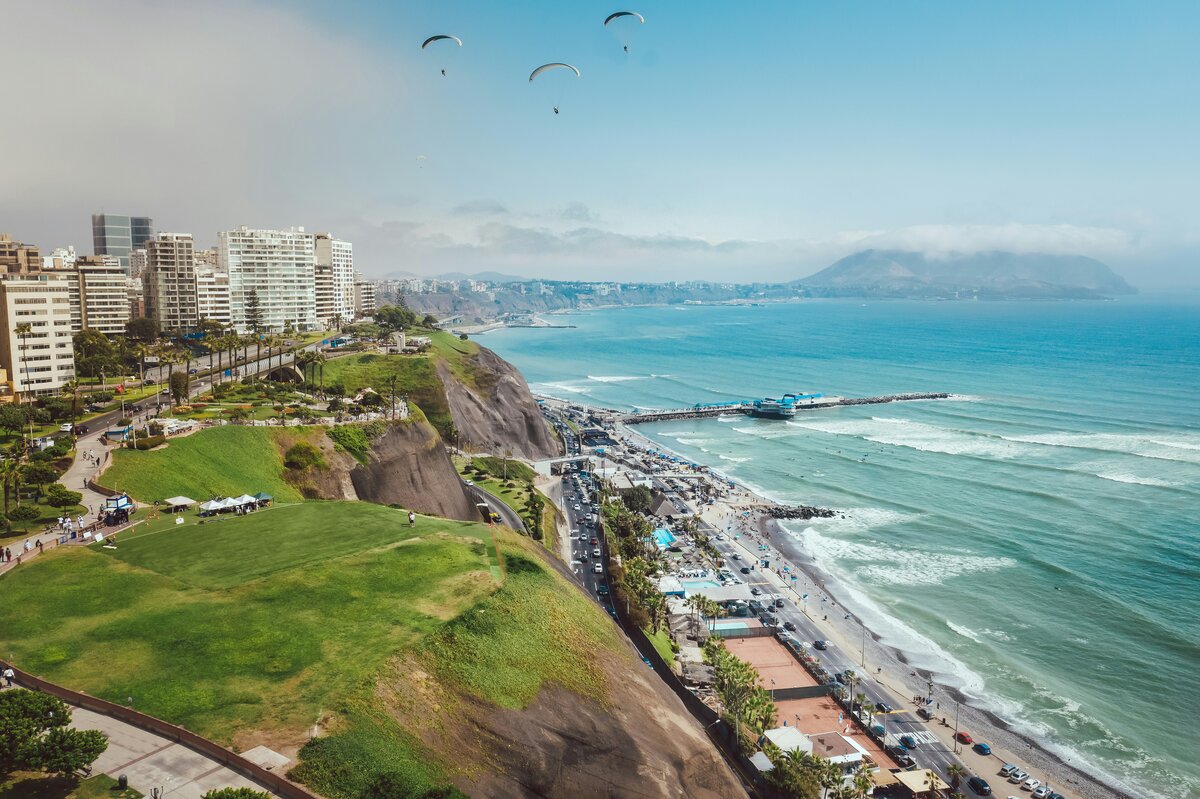 Lima coastline at sunset with clifftop restaurants