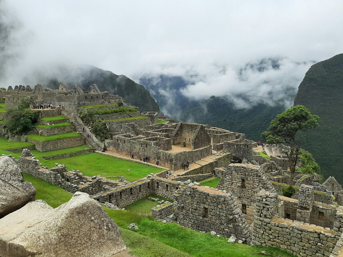 Sunrise over Machu Picchu ruins and misty mountains