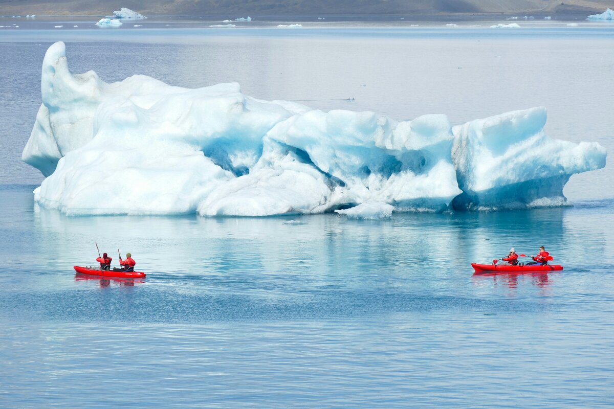 Sea kayakers exploring a calm polar bay