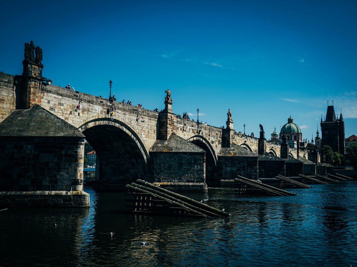 Prague Charles Bridge at dawn with Old Town silhouettes